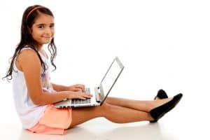 girl doing school work on laptop