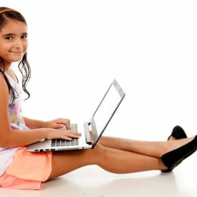 girl doing school work on laptop