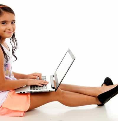 girl doing school work on laptop